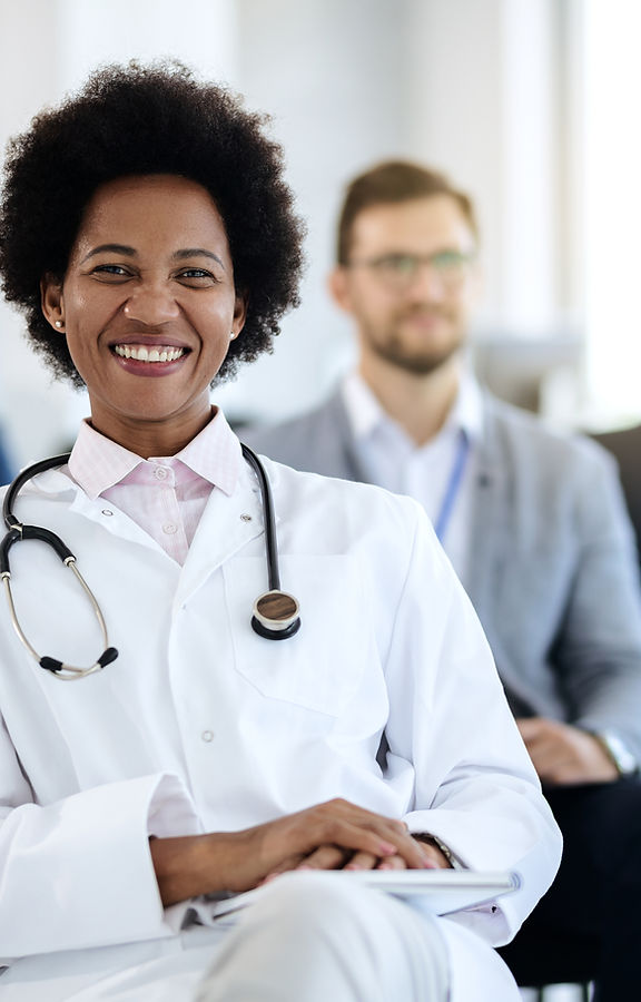happy-black-female-doctor-attending-educational-event-convention-center
