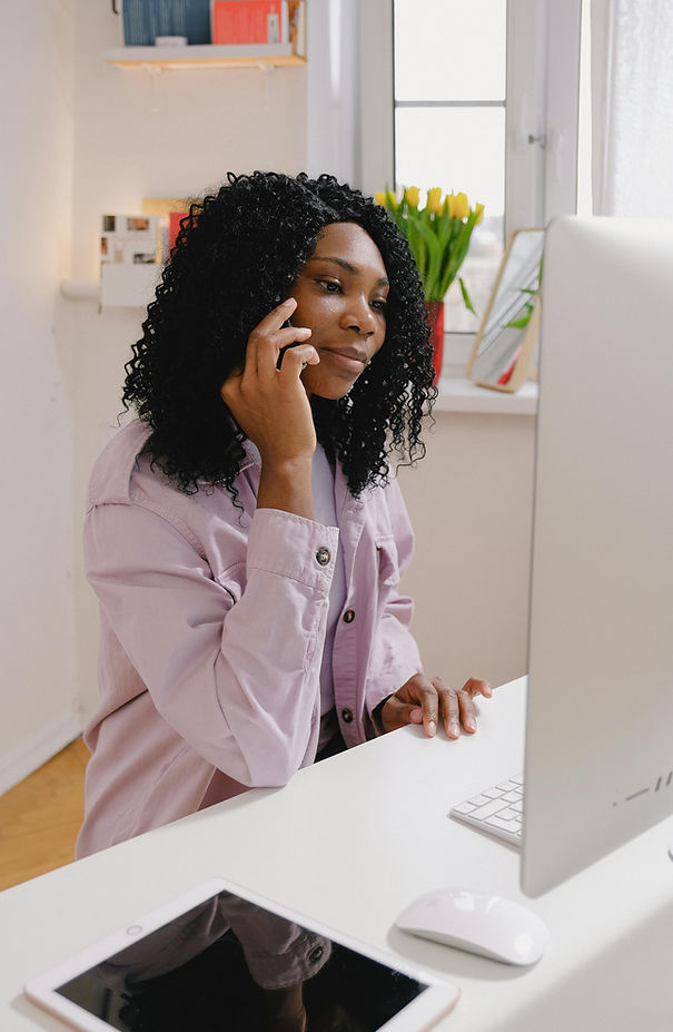 black woman on computer and phone